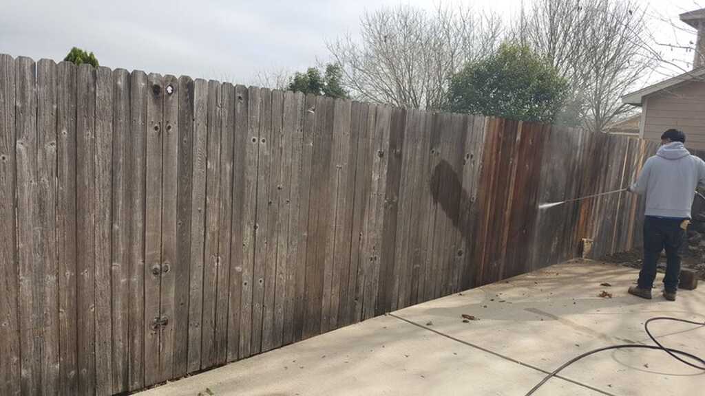 Pressure washing a wooden fence